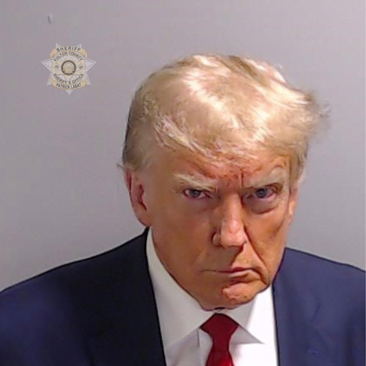 Trump getting his picture taken for his mugshot where he was reported at 6’3 and 215 lbs.
