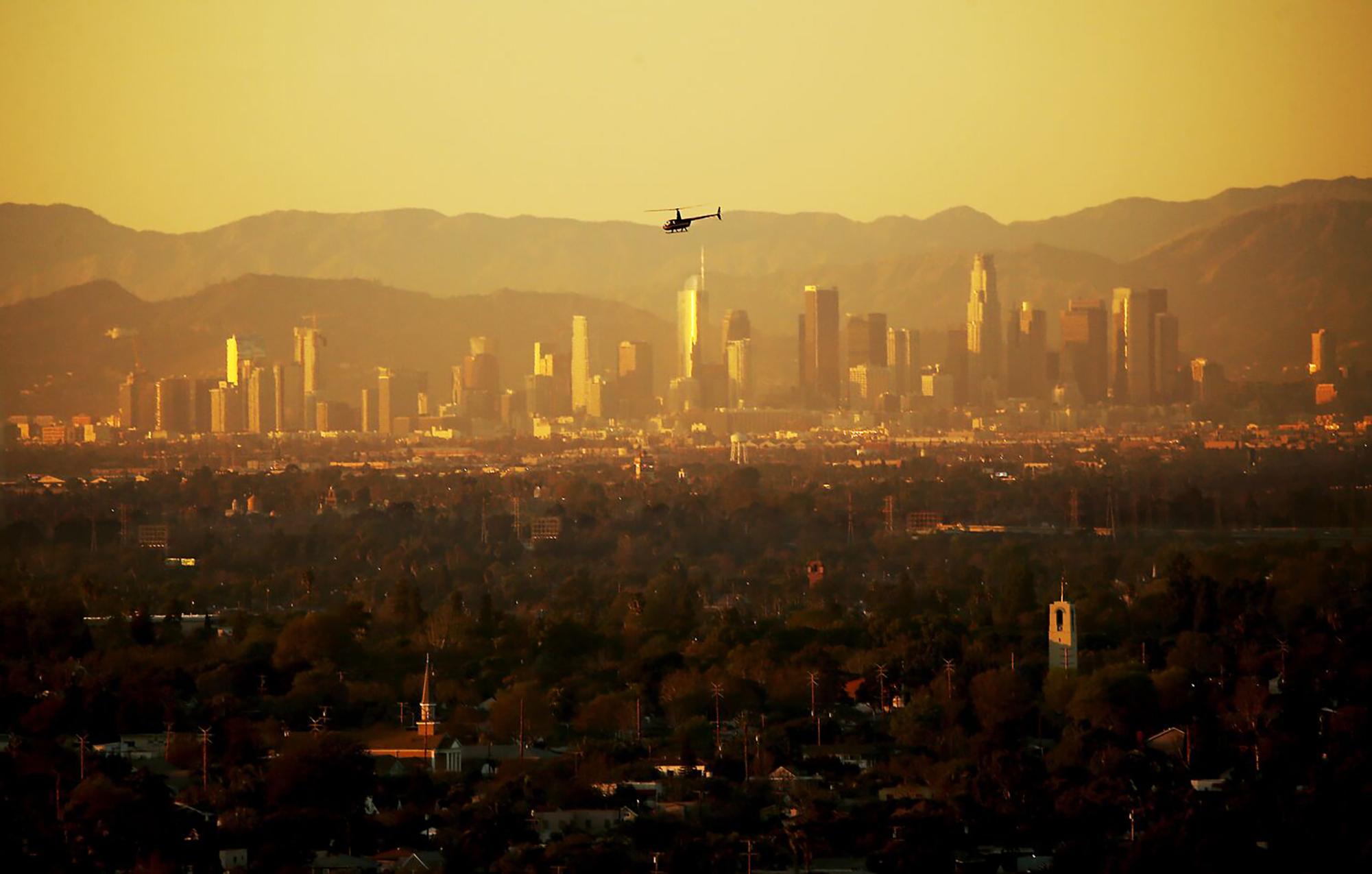 A helicopter flies across the hazy atmosphere of the Los Angeles Basin. High temperatures often lead to more pollutants in the air. (Luis Sinco/Los Angeles Times/TNS) ©2023 Los Angeles Times. Visit at latimes.com. Distributed by Tribune Content Agency, LLC.