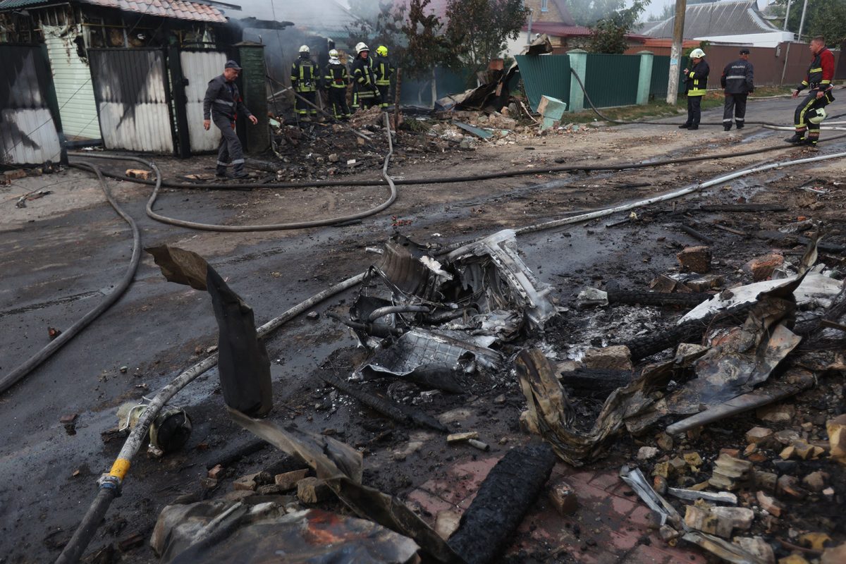 Firefighters work on a site following a missile attack in a village outside Kyiv.
