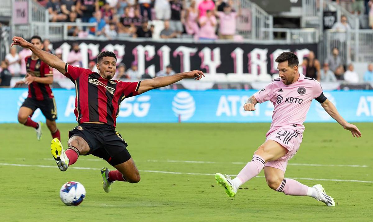 Inter Miamis Lionel Messi (10) takes a first-half shot at goal as Atlanta United defender Miles Robinson (12) applies pressure during a Leagues Cup group stage match at DRV PNK Stadium on Tuesday, July 25, 2023, in Fort Lauderdale, Florida. (Matias J. Ocner/Miami Herald/TNS)