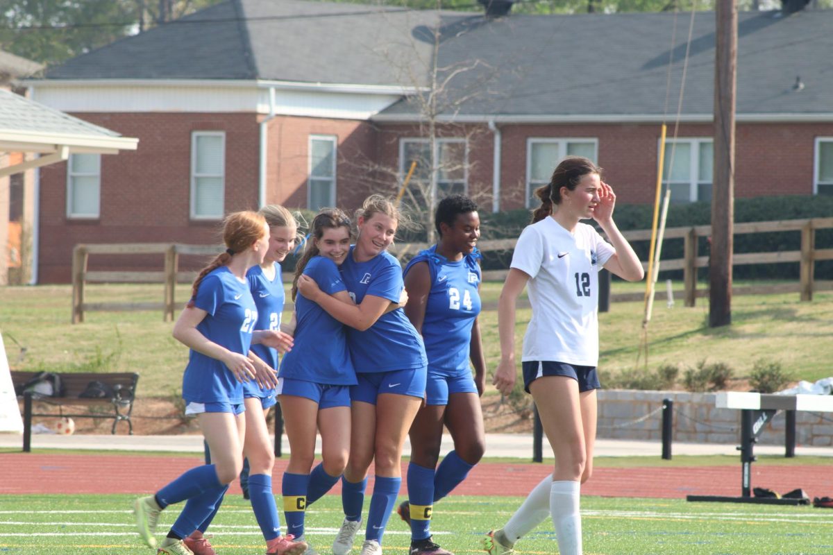 Paideia’s Girls Varsity Soccer players in celebrate after a goal last season