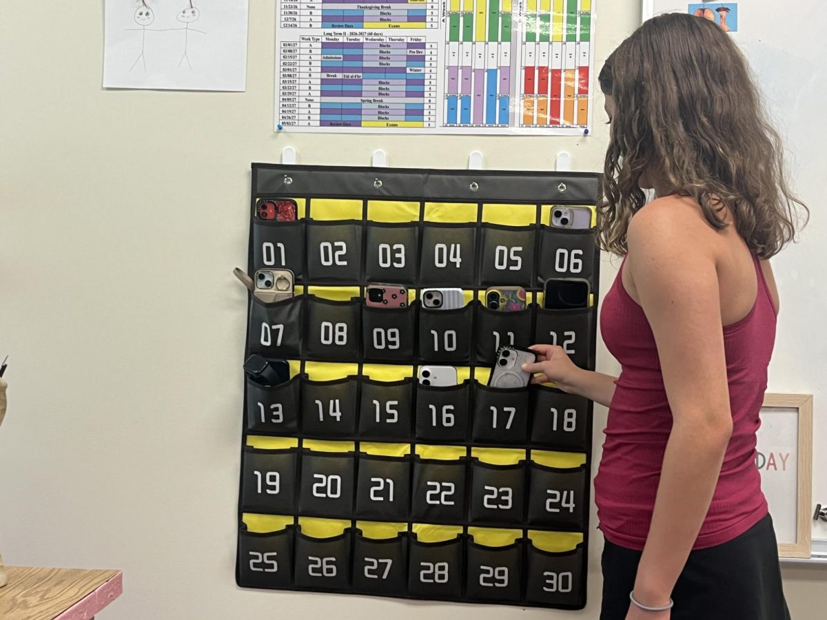 Students place cell phones in pockets before Kim Mansion's precalculus honors class.